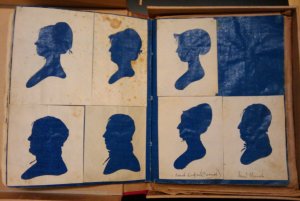 A book of cut silhouettes, all backed with bright blue paper